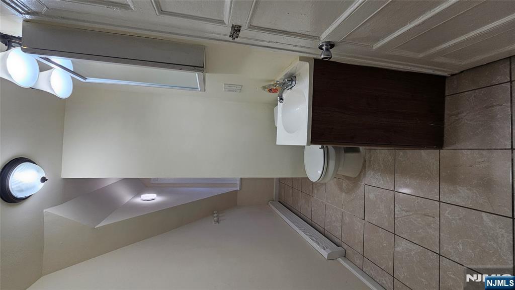 78 North Arlington Avenue, Unit 3 East Orange, NJ 07017 - Photo 4 of 13 a bathroom with a sink and a mirror