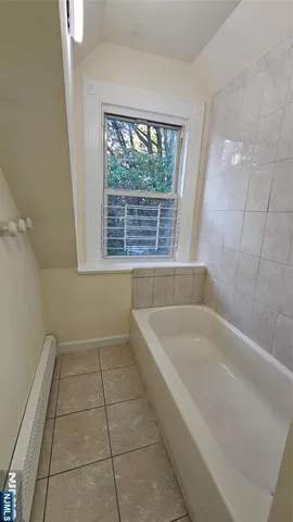 a spacious bathroom with a bathtub and window
