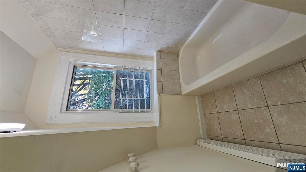 78 North Arlington Avenue, Unit 3 East Orange, NJ 07017 - Photo 5 of 13 a spacious bathroom with a bathtub and window
