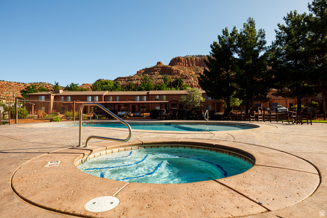 6 300th Road North, Unit I6 Kanab, UT 84741 - Photo 32 of 37 Community pool featuring a patio area, a hot tub, and a mountain view