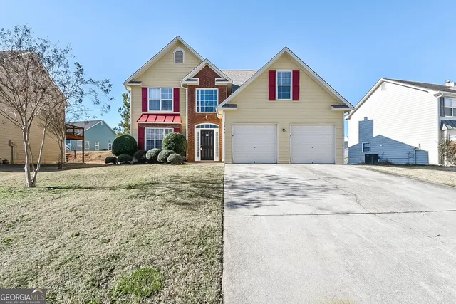 a front view of a house with a yard