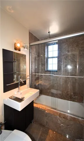 a room with a sink and chandelier