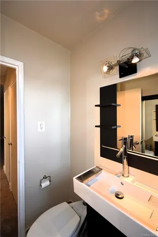 a bathroom with a sink vanity and a toilet