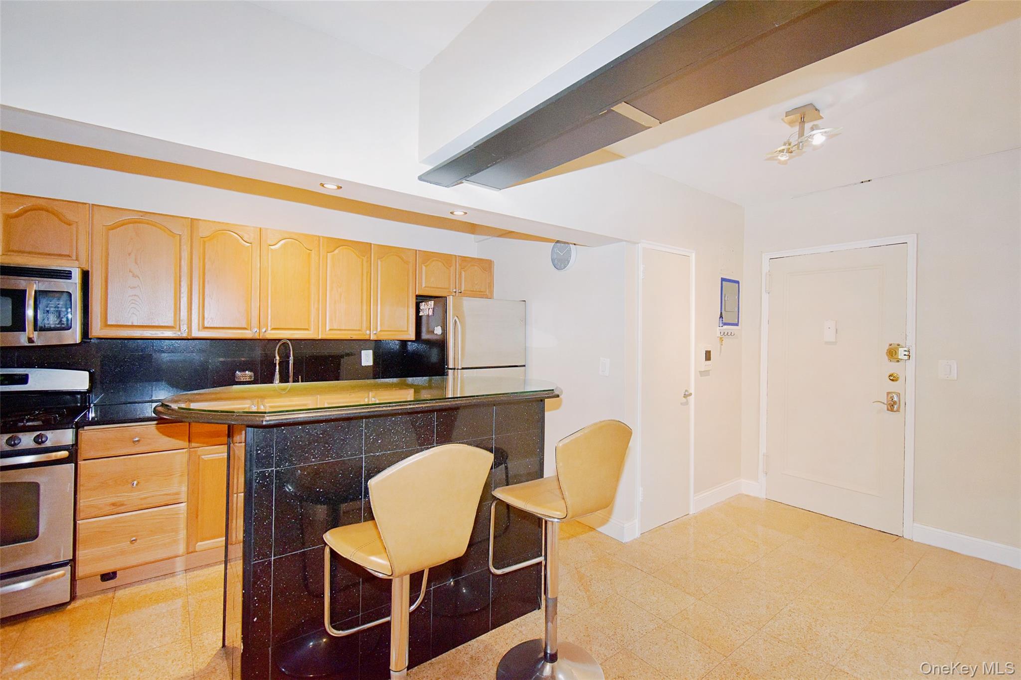 796 Bronx River Road, Unit B38 Bronxville, NY 10708 - Photo 3 of 21 a living room with stainless steel appliances furniture a dining table and kitchen view