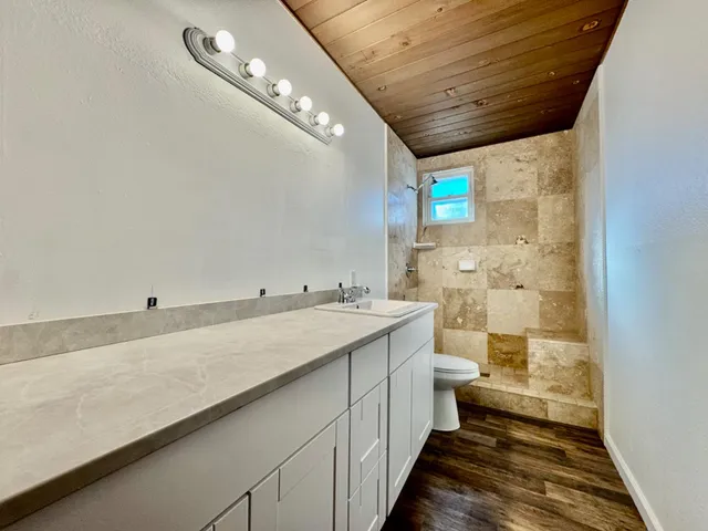 a bathroom with a toilet sink and mirror