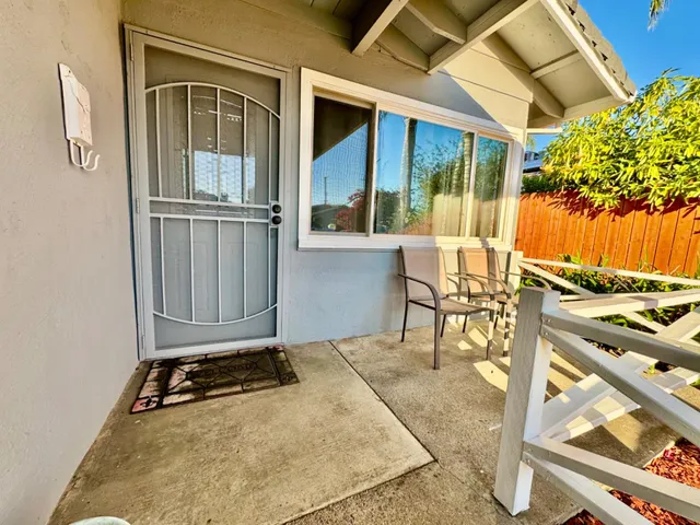 a backyard of a house with table and chairs