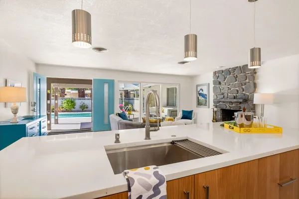 a living room with fireplace furniture and a large window