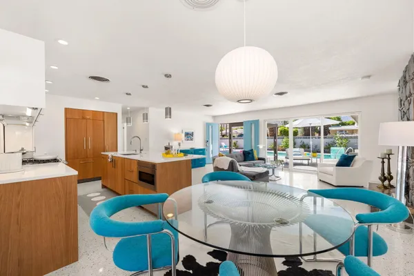 a living room with furniture a table and chairs
