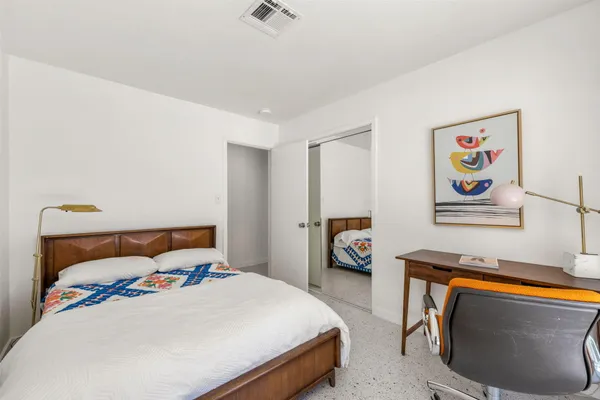 a bedroom with a bed and a couch
