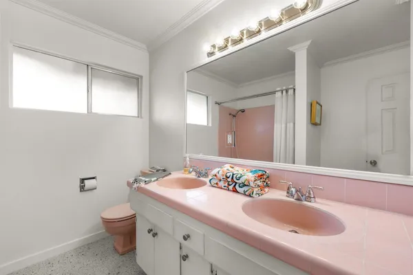 a bathroom with a granite countertop sink a toilet and a mirror