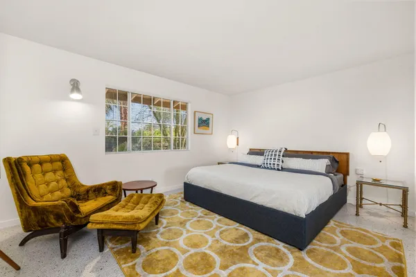 a bedroom with a bed and a couch