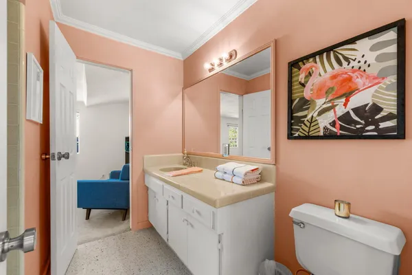 a bathroom with a toilet a sink and a mirror