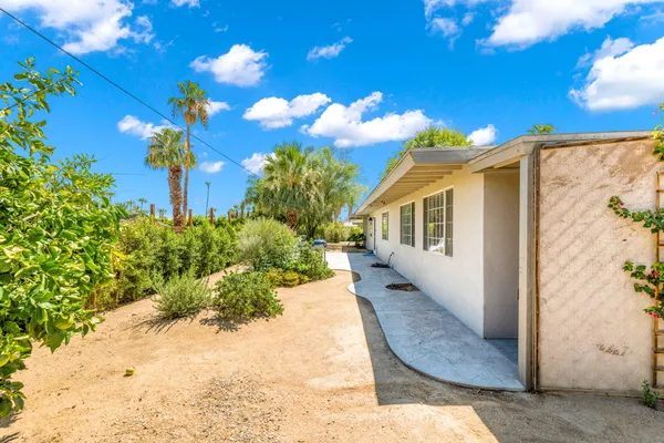 a view of a house with a backyard