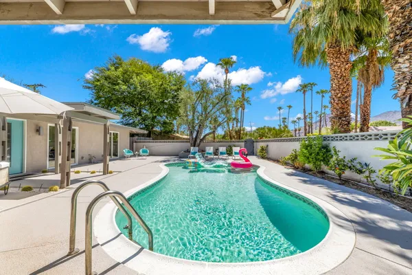 a view of a backyard with swimming pool