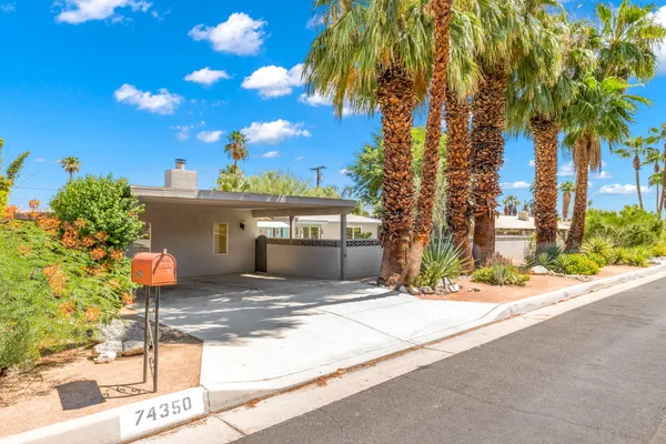 a view of a house with a tree in front