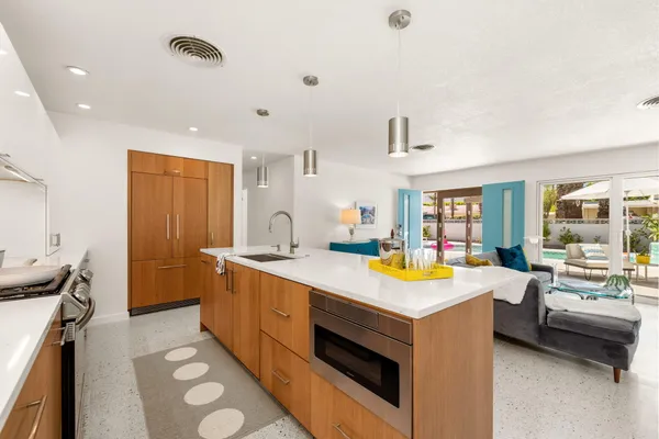a kitchen with a sink and a stove top oven