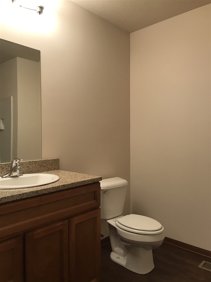 6915 Winterberry Road Loves Park, IL 61111 - Photo 14 of 15 a bathroom with a granite countertop toilet and a sink
