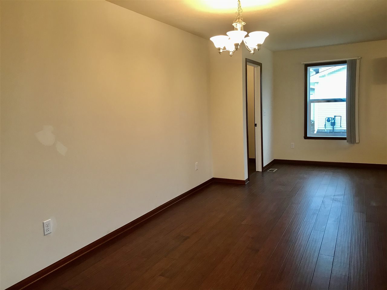 6915 Winterberry Road Loves Park, IL 61111 - Photo 5 of 15 a view of a room with wooden floor and chandelier