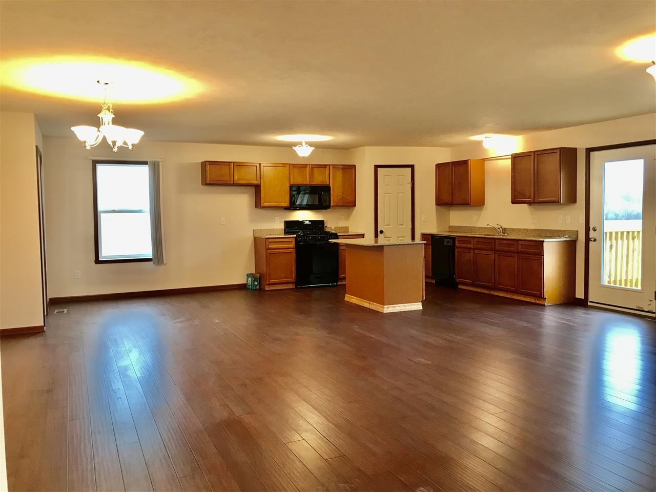 6915 Winterberry Road Loves Park, IL 61111 - Photo 8 of 15 a view of a kitchen with kitchen island wooden floors and stainless steel appliances