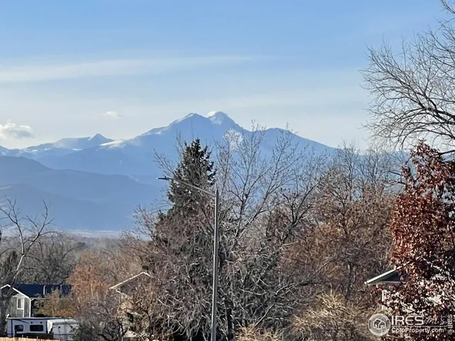 a view of a house with a mountain in the background