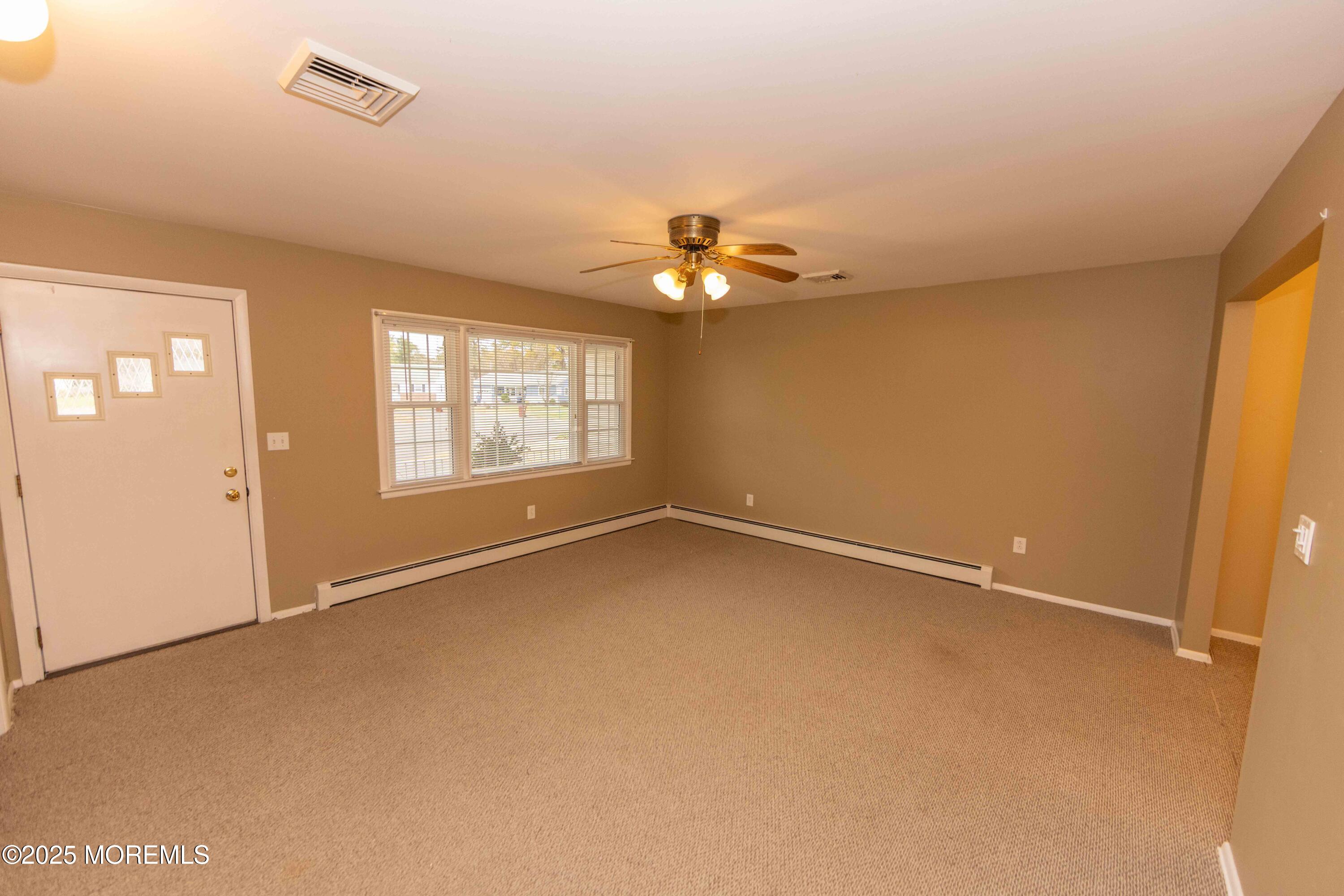 31 Southampton Road Toms River, NJ 08757 - Photo 4 of 14 wooden floor in an empty room with a window