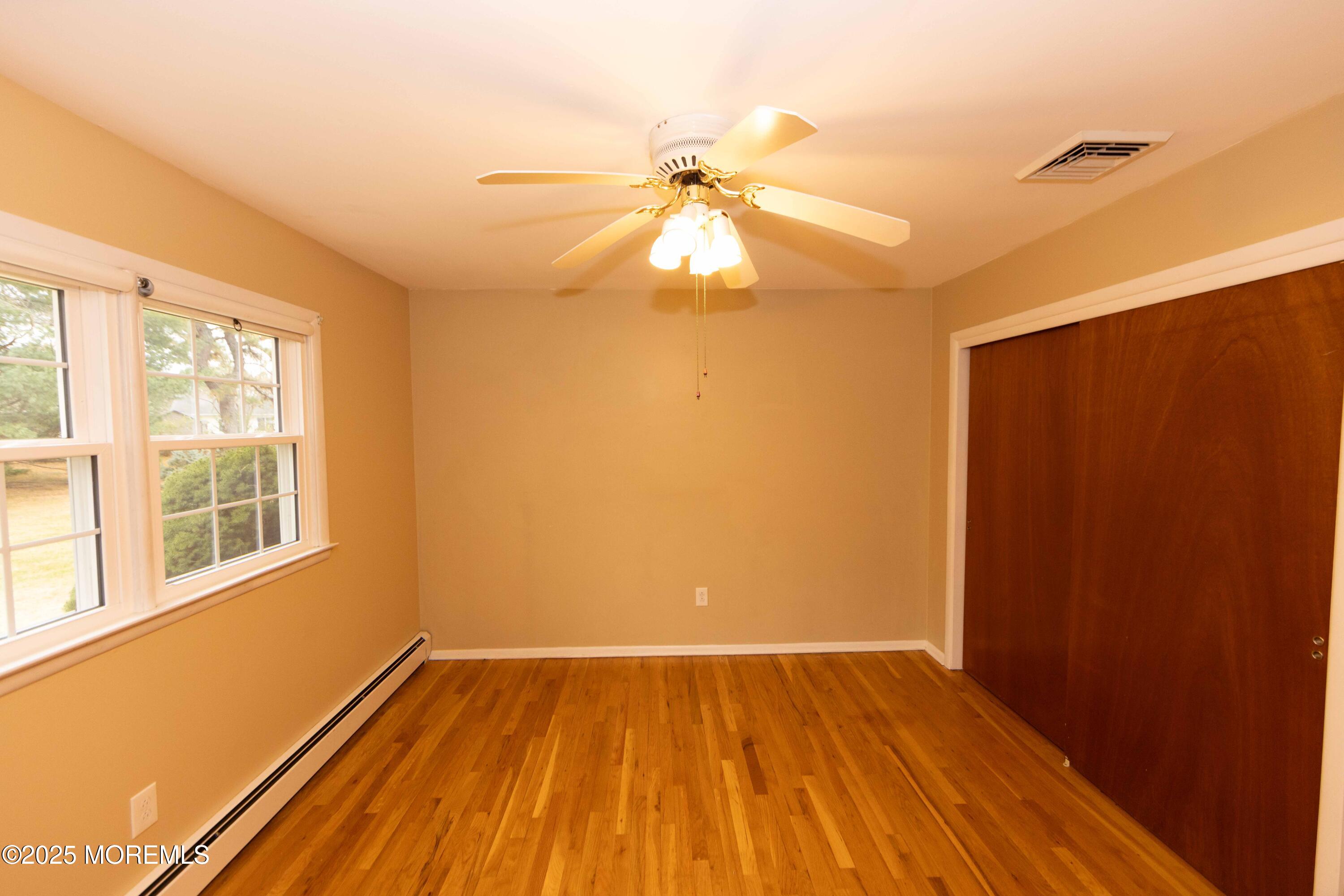 31 Southampton Road Toms River, NJ 08757 - Photo 8 of 14 a view of an empty room with wooden floor and a window