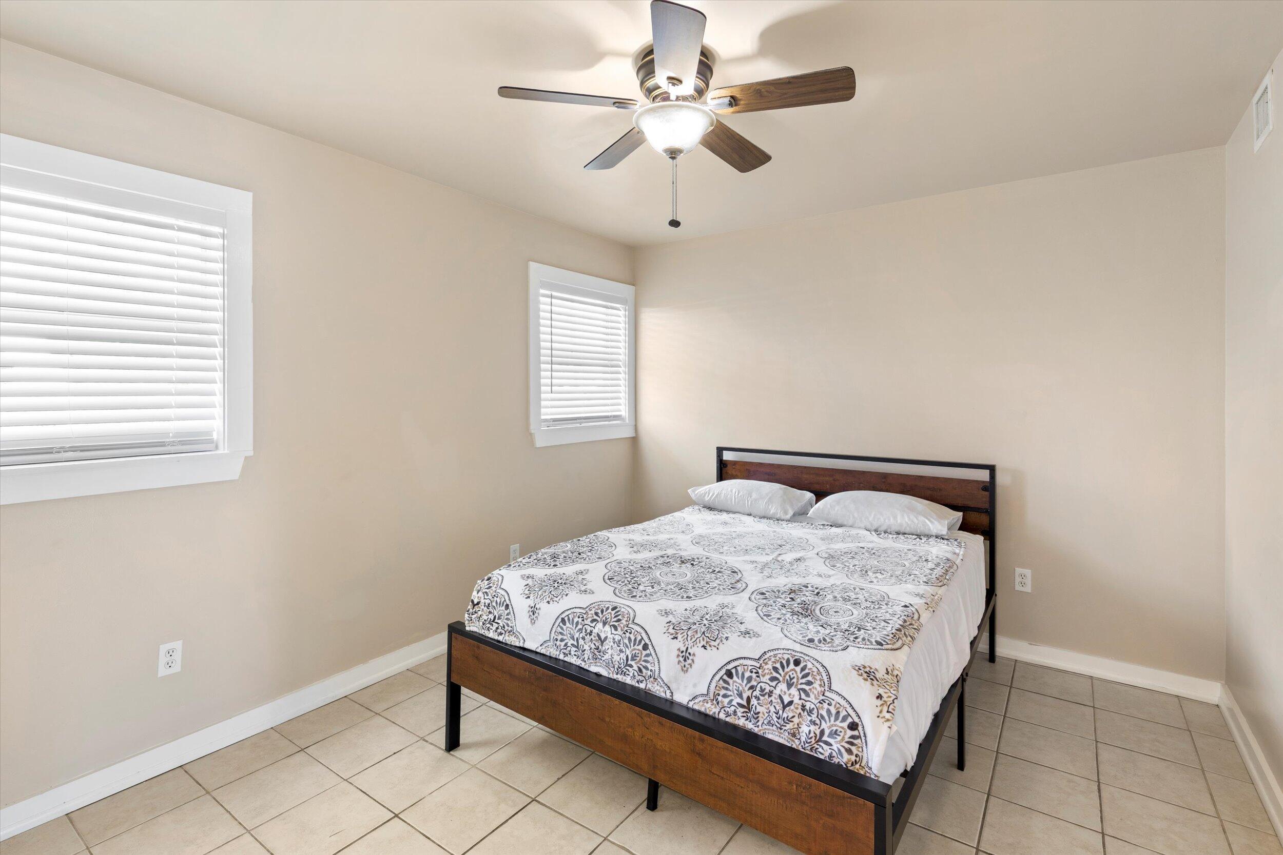 201 Coppitt Road, Unit 104C Key West, FL 33040 - Photo 11 of 18 a bed sitting in a bedroom next to a window