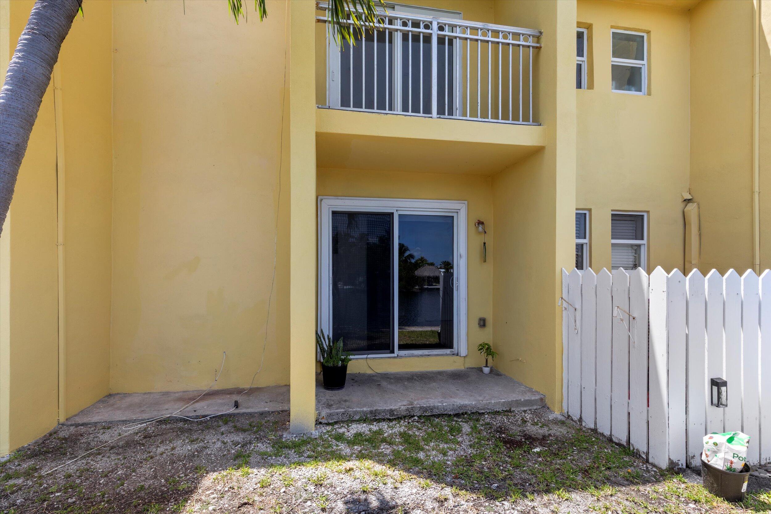 201 Coppitt Road, Unit 104C Key West, FL 33040 - Photo 13 of 18 a front view of a house with a porch