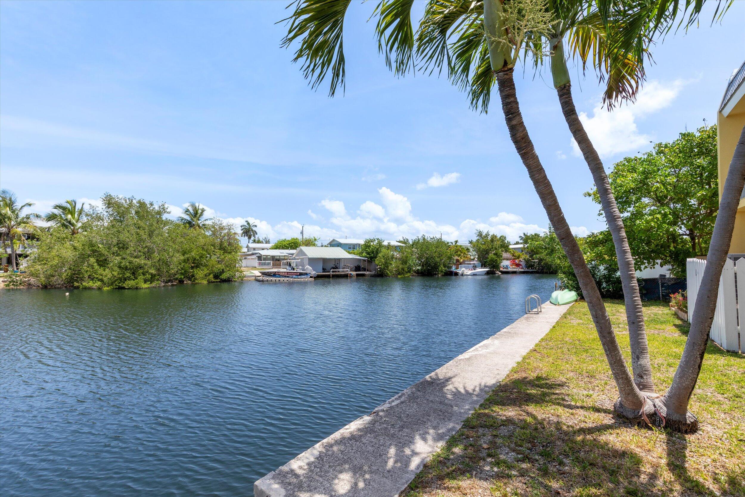 201 Coppitt Road, Unit 104C Key West, FL 33040 - Photo 14 of 18 a view of a lake with a palm trees