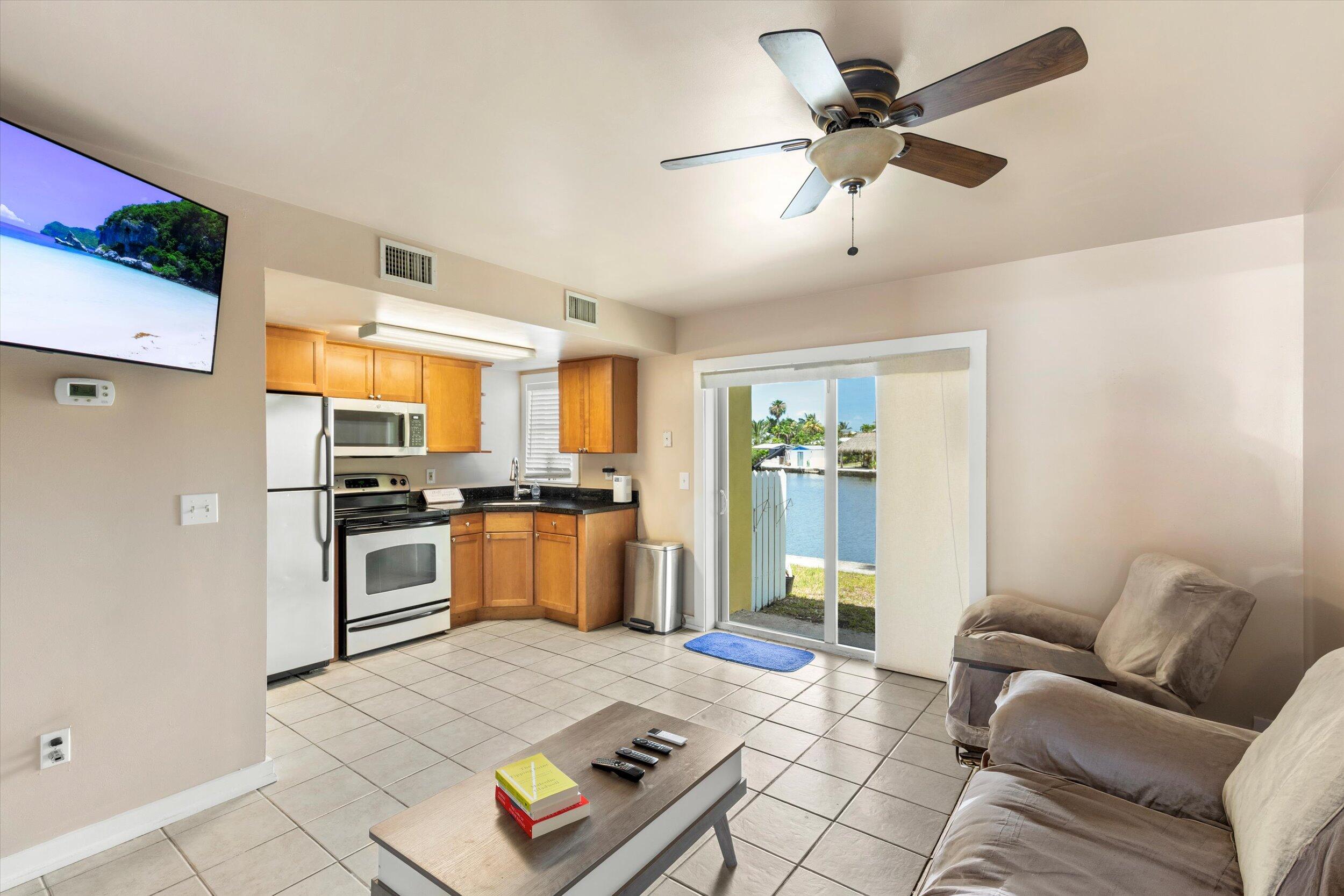 201 Coppitt Road, Unit 104C Key West, FL 33040 - Photo 3 of 18 a living room with furniture and kitchen view