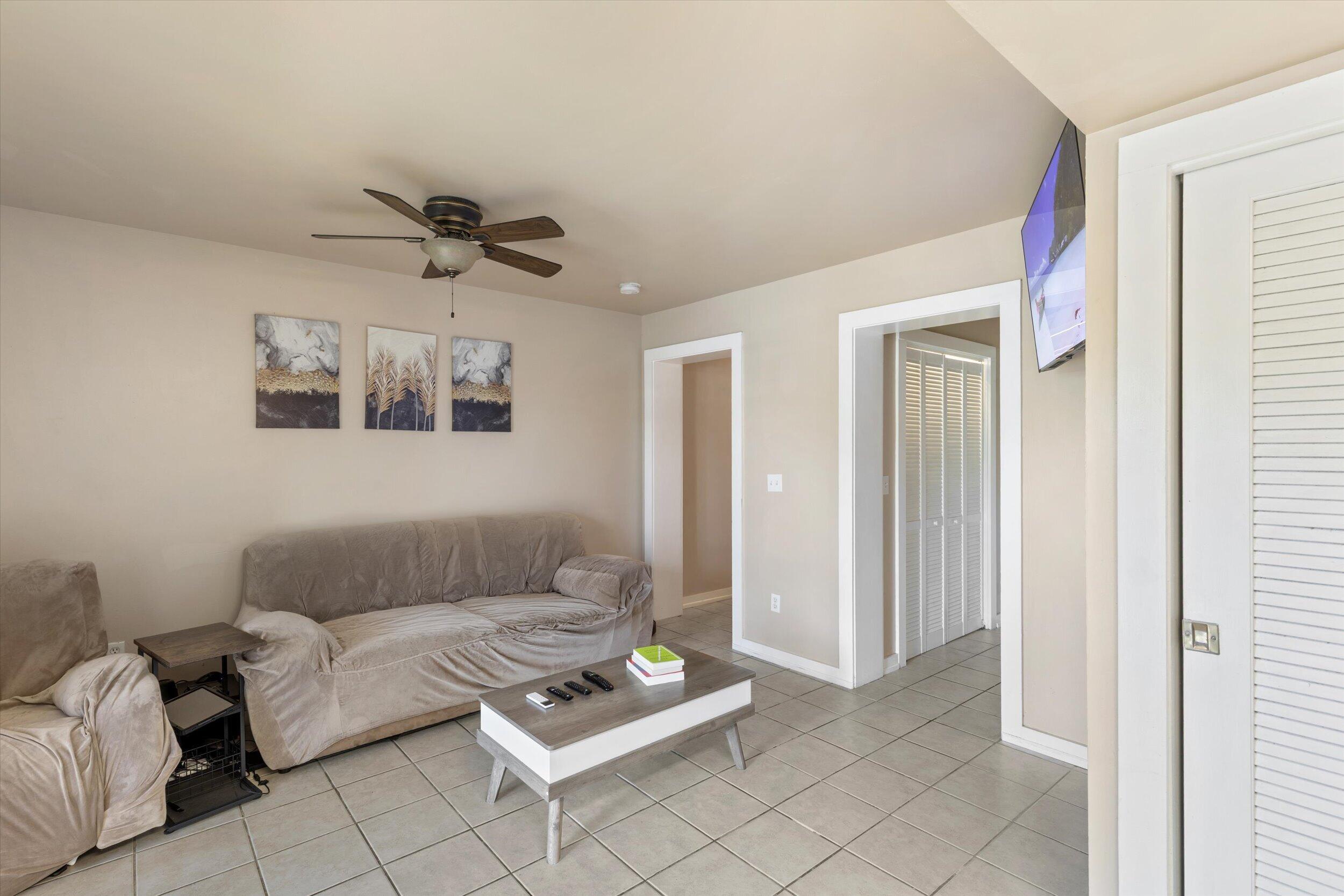 201 Coppitt Road, Unit 104C Key West, FL 33040 - Photo 5 of 18 a living room with furniture and a ceiling fan