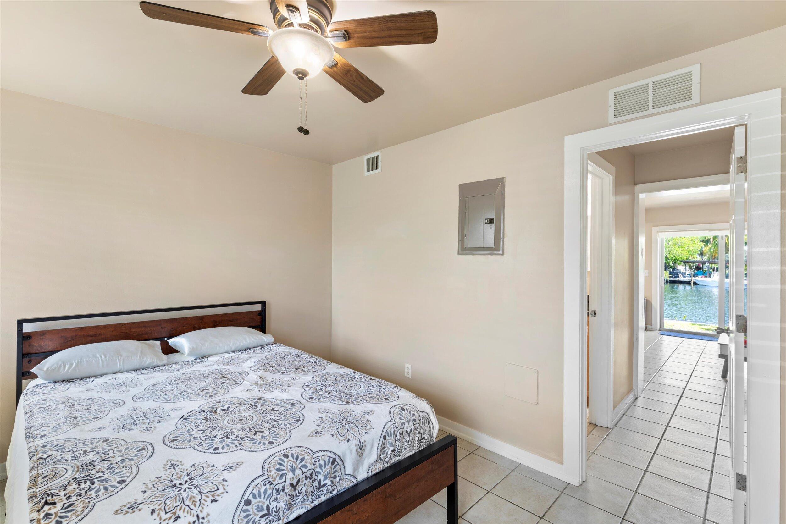 201 Coppitt Road, Unit 104C Key West, FL 33040 - Photo 10 of 18 a bedroom with a bed and a chandelier