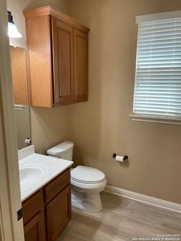 a bathroom with a sink a toilet and a window