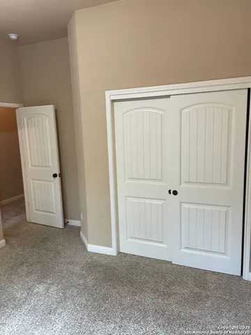 an empty room with a wooden door