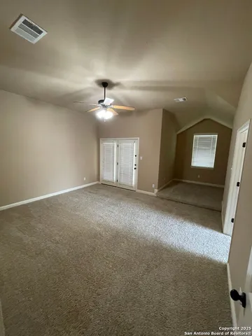 an empty room with a empty space and chandelier fan