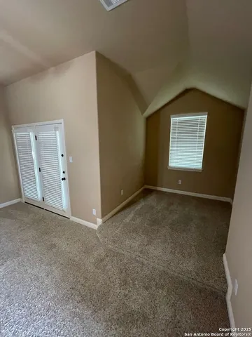 an empty room with windows and closet