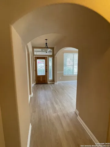 a view of a room with wooden floor and window