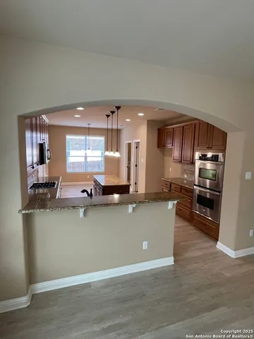 a kitchen with stainless steel appliances a refrigerator sink and stove