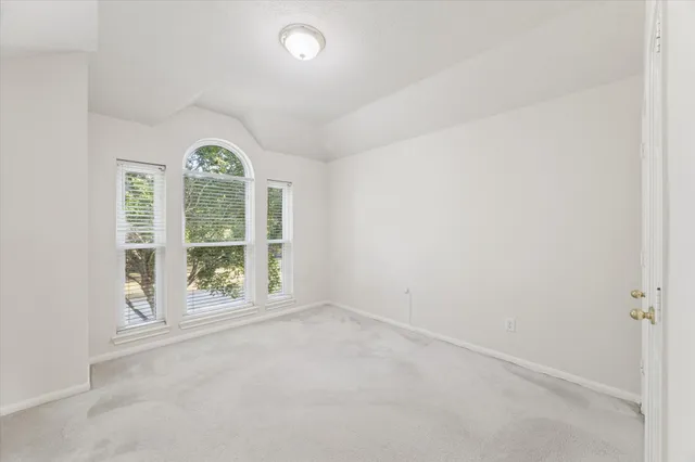 a view of an empty room with a ceiling fan