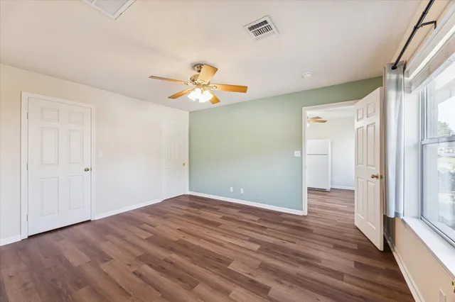 a view of a hallway with wooden floor