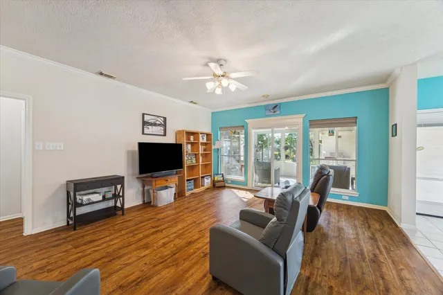 a living room with furniture and wooden floor