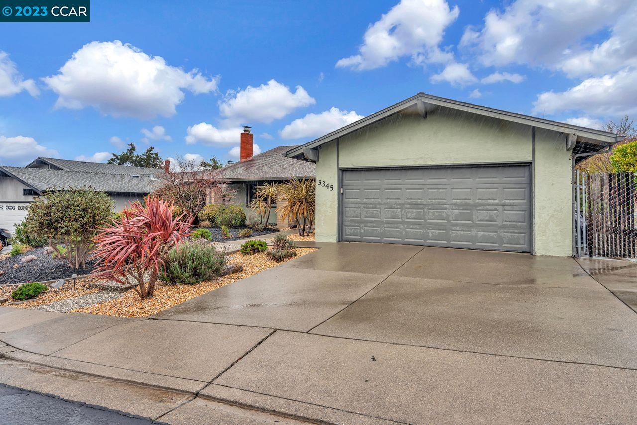 3345 Diablo Circle Pinole, CA 94564 - Photo 1 of 1 a front view of a house with a garage