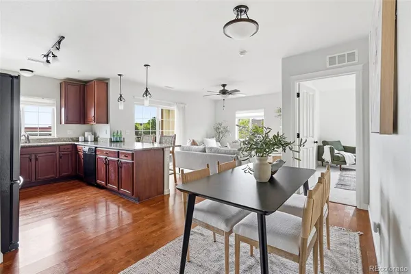 a kitchen with stainless steel appliances kitchen island granite countertop a dining table chairs and granite counter tops