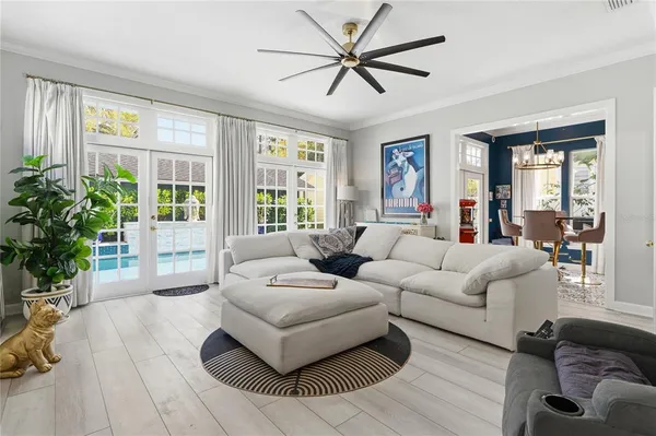 a living room with furniture and a chandelier