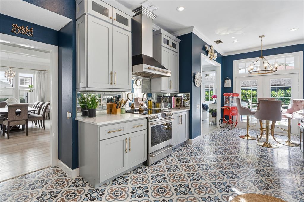 824 South Rome Avenue Tampa, FL 33606 - Photo 24 of 45 a kitchen with stainless steel appliances kitchen island granite countertop dining table chairs and a refrigerator