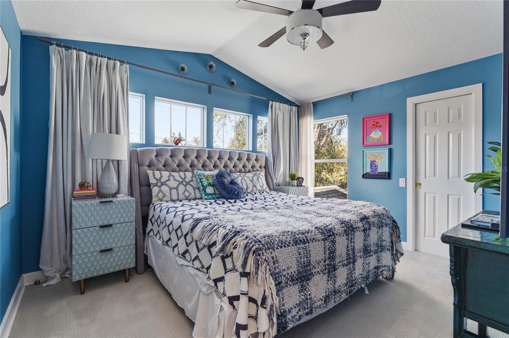 824 South Rome Avenue Tampa, FL 33606 - Photo 35 of 45 a bedroom with a large bed and a chandelier