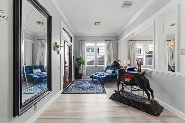 a view of a a dining room with furniture window and wooden floor