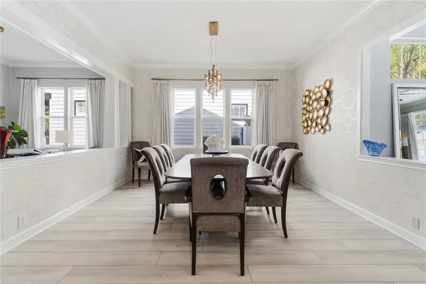 a living room with furniture a wooden floor and next to a window
