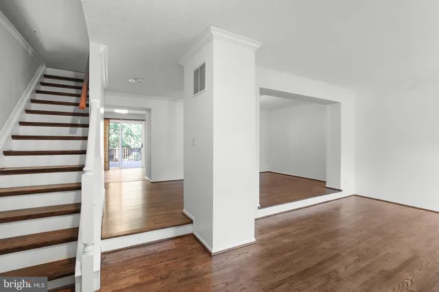 wooden floor in an empty room with a gallery