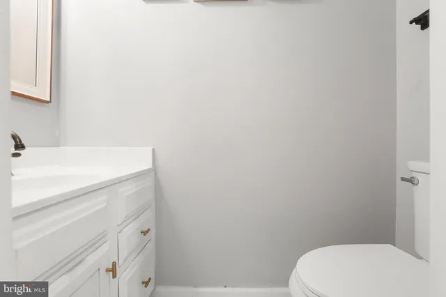 a bathroom with a sink a toilet and vanity